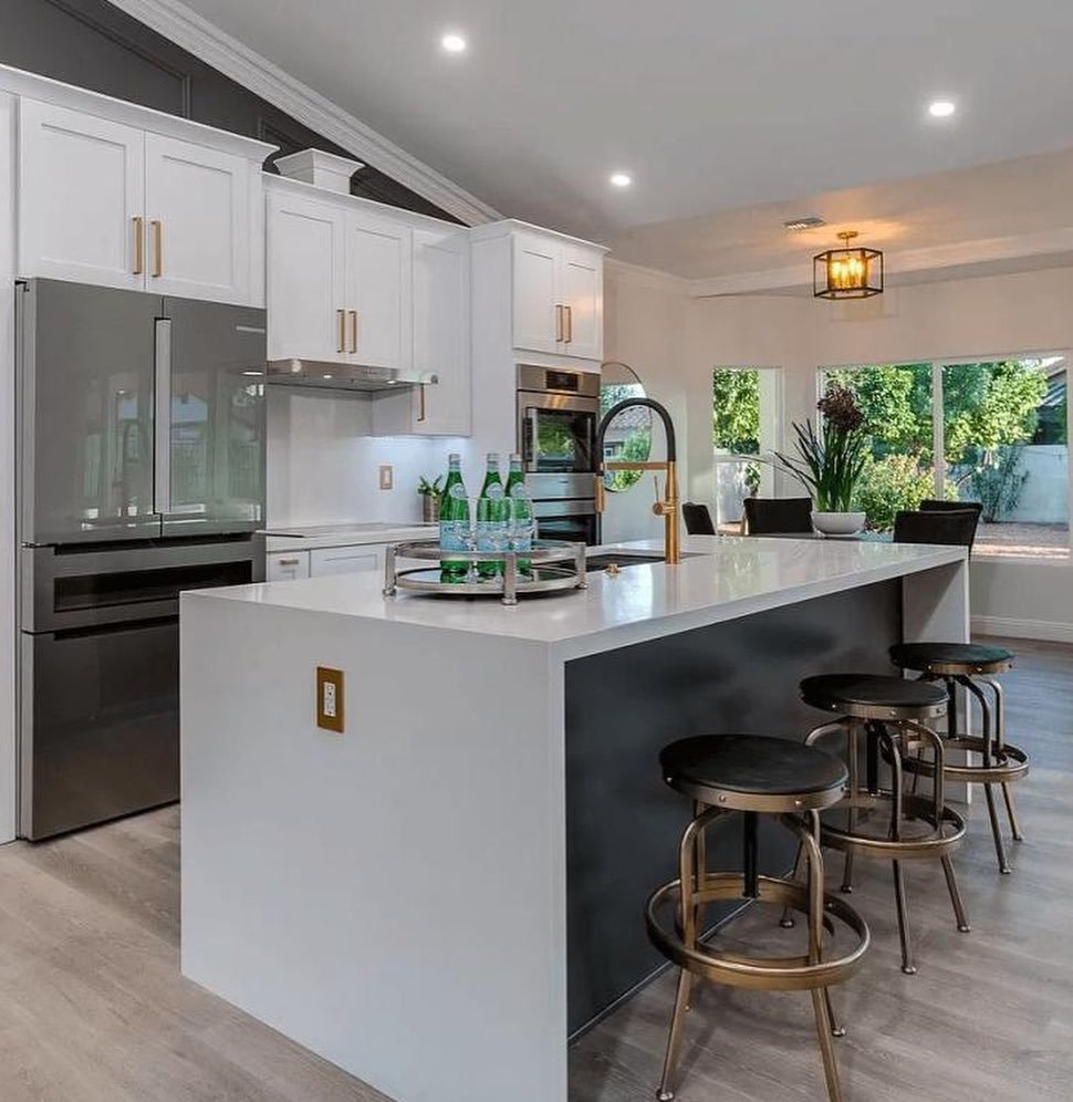 Elegant U-Shaped Kitchen With A Peninsula And Three Bar Stools
