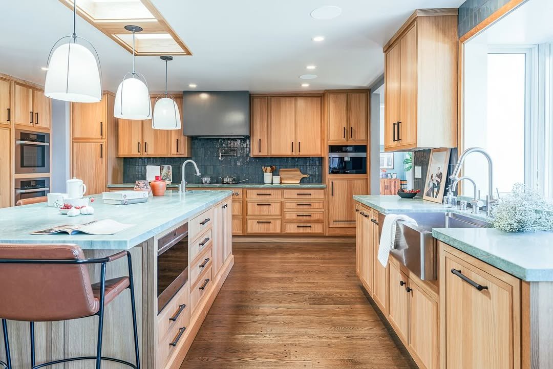 U-Shaped Kitchen With Quartzite Countertops And A Peninsula