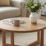 # 18 Round Coffee Table Living Room Ideas That Soften Your Space Rectangular coffee tables dominate living rooms creating predictable, boxy arrangements. The straight lines and sharp corners feel expected but rarely create the flowing, approachable spaces that make rooms truly welcoming and comfortable. Round coffee table living room ideas break this pattern through curved forms that improve traffic flow, soften hard edges, and create conversation-friendly seating arrangements. The circular shape changes how people interact with furniture and each other within living spaces. We're covering 18 round coffee table living room ideas that showcase versatility and style. These approaches work for various room sizes, design aesthetics, and functional needs proving round tables offer more than just shape variation. ## Why Round Coffee Tables Transform Living Rooms * **Improved Traffic Flow Around Furniture:** Curved edges eliminate corner navigation making movement through rooms easier and safer. It's like roundabouts versus intersections where circular flow prevents collisions. The shape particularly benefits homes with children or tight spaces requiring frequent passage. * **Conversation-Friendly Seating Arrangements:** Circular tables create equal access from all sides fostering better social interaction than rectangular counterparts. It's like round dining tables where everyone participates equally. The democratic shape encourages inclusive conversation rather than head-of-table dynamics. * **Visual Softness Balances Boxy Rooms:** Round forms provide organic contrast to rectangular sofas, rugs, and room architecture. It's like punctuation marks where curves break up linear monotony. The shape variation adds visual interest preventing boring uniformity. * **Flexible Placement Options:** Round tables work in various positions—centered, offset, or floating—adapting to different room configurations easily. It's like universal adapters where one shape fits multiple scenarios. The versatility allows repositioning as needs change without awkward appearance. ## 18 Round Coffee Table Living Room Ideas Create inviting flowing spaces with these round coffee table living room ideas that prove circular forms offer both style and function. ### Marble Top with Brass Base Choose round marble-topped table on brass pedestal base creating elegant focal point. The natural stone adds luxury while metal base provides sculptural presence. It's like jewelry for living rooms where materials create sophistication. Select white or gray marble maintaining light feeling in space. The substantial table anchors seating arrangements while brass adds warm metallic glow. This round coffee table living room choice delivers timeless elegance through quality materials. ### Nesting Round Tables Set Use set of nesting round tables in graduated sizes providing flexibility for various needs. The multiple surfaces adapt for entertaining or everyday use. It's like Russian dolls where compact storage transforms into expanded function. Choose tables in same finish or mix materials creating visual interest. Pull smaller tables out when hosting then nest them conserving space. This round coffee table living room solution maximizes versatility in dynamic living spaces. ### Glass Top with Wood Base Select transparent glass top on wooden pedestal creating light visual weight. The see-through surface maintains open feeling while wood adds warmth. It's like invisible furniture where function exists without visual bulk. The glass allows rugs showing through creating layered depth. Choose substantial wood base preventing tippy feeling. This round coffee table living room idea suits small spaces needing furniture without heaviness. ### Oversized Round Ottoman Use large round ottoman as coffee table providing soft surface for feet and flexible seating. The upholstered form adds comfort and casual elegance. It's like giant cushions where softness replaces hard surfaces. Add tray on top creating stable surface for drinks and accessories. Choose durable fabrics withstanding daily use. This round coffee table living room alternative creates family-friendly flexibility serving multiple purposes. ### Woven Natural Fiber Choose round table woven from rattan, seagrass, or jute adding organic texture. The natural materials bring casual coastal or bohemian character. It's like bringing outdoors inside where natural materials create relaxed atmosphere. The lightweight construction allows easy repositioning. Pair with neutral or colorful décor depending on desired aesthetic. This round coffee table living room choice adds textural interest and natural warmth. ### Black Metal Frame with Wood Top Combine black metal base supporting round wood top creating modern industrial aesthetic. The contrasting materials add visual interest while maintaining clean lines. It's like bridges where engineering meets natural beauty. Choose darker woods like walnut or lighter oak depending on desired mood. The metal provides sturdy structure while wood adds warmth. This round coffee table living room design suits contemporary and transitional spaces. ### Concrete Round Surface Select round concrete table creating industrial-modern statement piece. The substantial material adds architectural presence and contemporary edge. It's like sculpture where functional furniture becomes art. Seal concrete properly preventing staining from spills. The heavy weight provides stability families with children appreciate. This round coffee table living room choice delivers bold modern aesthetic through unexpected material. ### Vintage Drum Table Incorporate antique or vintage drum table adding collected character. The historical piece brings personality and craftsmanship modern furniture lacks. It's like family heirlooms where stories matter as much as function. Look for brass-topped drums, carved wood, or painted designs. The unique piece becomes conversation starter and room anchor. This round coffee table living room approach adds soul through one-of-a-kind vintage finds. ### Lucite and Brass Combination Choose clear acrylic round top on brass base creating glamorous contemporary look. The transparent surface provides function without visual weight while brass adds luxury. It's like fashion jewelry where affordable materials create expensive appearance. The lucite suits small spaces maintaining open sight lines. Polish both materials regularly maintaining sparkle. This round coffee table living room solution delivers glamour through smart material pairing. ### Rustic Reclaimed Wood Select round table crafted from reclaimed wood creating sustainable character-rich piece. The aged wood brings history and authentic patina. It's like architectural salvage where past lives add present beauty. Each table features unique grain and weathering patterns. The substantial wood grounds modern or farmhouse interiors beautifully. This round coffee table living room choice adds warmth through genuine aged materials. ### Tufted Upholstered Surface Choose round table with tufted upholstered top creating soft elegant surface. The fabric adds luxury while button tufting provides dimensional detail. It's like upholstered furniture where softness replaces hard tabletops. Select performance fabrics resisting stains and wear. Add decorative tray creating stable surface for drinks. This round coffee table living room option adds sophisticated softness to formal living rooms. ### Live Edge Wood Slab Use natural live edge wood round creating organic one-of-a-kind centerpiece. The irregular edge celebrates wood's natural form. It's like bringing forest slices indoors where nature's art becomes furniture. Each piece features unique grain, knots, and edge variations. Seal wood properly protecting from moisture damage. This round coffee table living room choice adds organic beauty through nature's own design. ### Mid-Century Modern Walnut Select classic mid-century round table in walnut creating retro-inspired sophistication. The warm wood and period design add timeless style. It's like vintage clothing where classic never goes out of fashion. Look for tapered legs and clean lines defining mid-century aesthetic. The warm walnut suits various color schemes beautifully. This round coffee table living room design delivers enduring style through iconic period furniture. ### Mirrored Round Cocktail Table Choose round table with mirrored surfaces creating glamorous light-reflecting centerpiece. The reflective quality amplifies light while adding Hollywood Regency style. It's like disco balls where surfaces multiply sparkle. Keep mirrors clean maintaining maximum reflection and glamour. The shiny surface suits formal elegant living rooms. This round coffee table living room choice adds dramatic glamour through reflective surfaces. ### Minimalist Pedestal Design Select simple round table on single central pedestal creating clean minimalist form. The understated design provides function without visual clutter. It's like haiku where simplicity communicates elegantly. Choose pedestal in wood, metal, or stone depending on aesthetic. The single support maximizes leg room around table. This round coffee table living room approach suits contemporary spaces valuing restraint. ### Wicker Coastal Style Incorporate round wicker or rattan table adding relaxed coastal character. The woven material brings texture and casual elegance. It's like beach houses where natural materials create vacation feeling. Choose natural finish or white-painted wicker depending on desired look. The lightweight construction allows easy seasonal repositioning. This round coffee table living room style creates laid-back coastal atmosphere. ### Stone Aggregate Modern Select round table featuring terrazzo or stone aggregate creating textured contemporary surface. The speckled appearance adds visual interest and durability. It's like granite countertops where practicality meets beauty. The sealed surface resists scratches and stains well. Choose colors complementing your existing palette. This round coffee table living room choice delivers modern durability through composite stone materials. ### Hammered Metal Artisan Choose round table with hammered metal top showcasing artisan craftsmanship. The hand-worked surface adds texture and unique character. It's like handmade pottery where human touch shows beautifully. Select brass, copper, or silver-toned metals depending on room's palette. The dimensional surface catches light creating visual interest. This round coffee table living room piece adds artisanal quality through handcrafted details. ## Styling Round Coffee Tables Successfully * **Use Trays for Organization:** Corral items on round surfaces using decorative trays preventing scattered appearance. It's like place settings where boundaries create order. The contained arrangement maintains visual calm on circular surfaces. * **Balance Height with Seating:** Choose tables 16 to 18 inches tall sitting appropriately relative to sofa seat height. It's like ergonomics where proportions affect comfort and function. The proper height prevents awkward reaching or bending. * **Leave Negative Space:** Avoid covering entire surface with objects allowing table's form showing. It's like framing where empty space matters. The breathing room lets beautiful table materials and shapes shine. * **Consider Traffic Patterns:** Position tables allowing 18 inches minimum clearance for comfortable passage around furniture. It's like sidewalks where adequate width prevents congestion. The spacing ensures smooth flow through living spaces. ## Frequently Asked Questions About Round Coffee Table Living Rooms ### Do Round Tables Work in Small Living Rooms? Yes—round tables often work better in tight spaces than rectangular ones eliminating sharp corners that consume visual space. The curved form creates better flow in compact rooms. Choose appropriate size maintaining adequate clearance around furniture for comfortable movement. Glass-topped or light-colored rounds maintain open feeling in small spaces. The shape's flexibility allows various placement options adapting to challenging room configurations better than rigid rectangles. ### What Size Round Coffee Table Do You Need? Select diameter two-thirds your sofa's length as general guideline. For standard 84-inch sofas, choose 36 to 48-inch round tables. Ensure at least 18 inches clearance between table edge and surrounding furniture allowing comfortable leg room and passage. Smaller spaces benefit from 30 to 36-inch tables while larger rooms accommodate 48 to 54-inch rounds. Consider your specific room dimensions and traffic patterns when selecting size. ### How Do You Style Round Coffee Tables? Use rule of three grouping objects in triangular arrangements rather than linear rows. Include varied heights creating visual interest. Layer books, decorative objects, and fresh flowers. Add tray corraling smaller items preventing scattered appearance. Keep styling edited allowing table's form showing. The round shape handles asymmetric arrangements beautifully. Rotate seasonal styling preventing stale appearance while maintaining curated restraint. ### Are Round Tables Harder to Find Than Rectangular? Round tables are less common than rectangular options but availability has improved as demand increases. Most furniture retailers now stock multiple round styles. The selection may be smaller requiring more searching for perfect piece. Custom and vintage markets offer unique round options unavailable in mainstream retail. The extra effort sourcing often rewards with more distinctive pieces than ubiquitous rectangular alternatives. ### Can You Use Multiple Round Tables Together? Nesting sets work beautifully providing flexibility without permanent commitment to multiple tables. Avoid using identical separate rounds together—vary sizes or heights creating intentional composition. Two different rounds at opposite conversation area ends can work when visually balanced. The key is intentional variety rather than accidental duplication. Mixing round with other shapes often creates more interesting arrangements than all circular forms. ## Embracing Circular Living Round coffee table living room ideas prove that breaking rectangular norms creates more flowing, welcoming spaces. The curved forms improve function while adding visual interest that boxy arrangements can't match. The simple shape change transforms how people move through and interact within living rooms. Start by evaluating your space's traffic flow and seating arrangement. Choose round tables scaled appropriately to room size and sofa dimensions. The shift to circular forms often surprises homeowners with improved functionality alongside aesthetic enhancement. Round coffee table living room